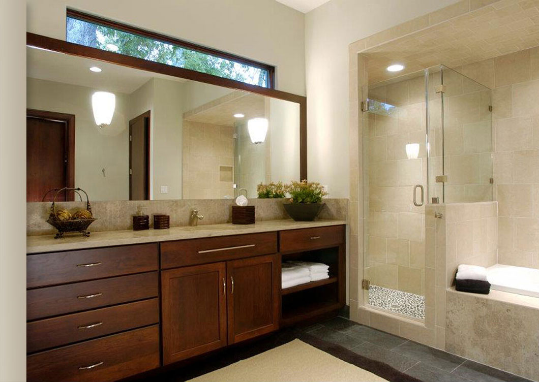 This modern bathroom features a large mirror, wood cabinets, double sinks, beige countertop, walk-in glass shower, and a built-in bathtub; towels and decorative plants are neatly arranged—perfect inspiration for modern bathrooms.