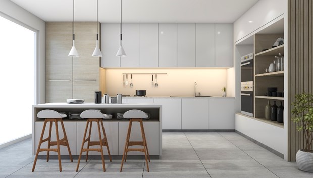 Modern kitchen with white cabinets, an island with three wooden bar stools, hanging pendant lights, and built-in appliances. Open shelves display decor items and a potted plant on the right. Large window brings in natural light—showcasing current trends.